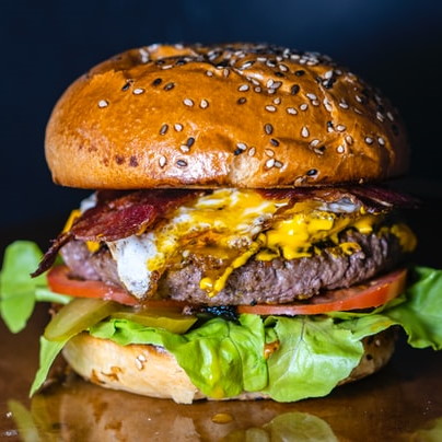 Close up of a hamburger on a glossy table
